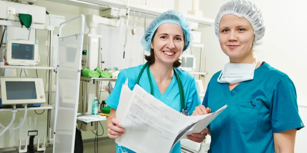 Anesthesiology professionals reviewing patient documents in a modern operating room.