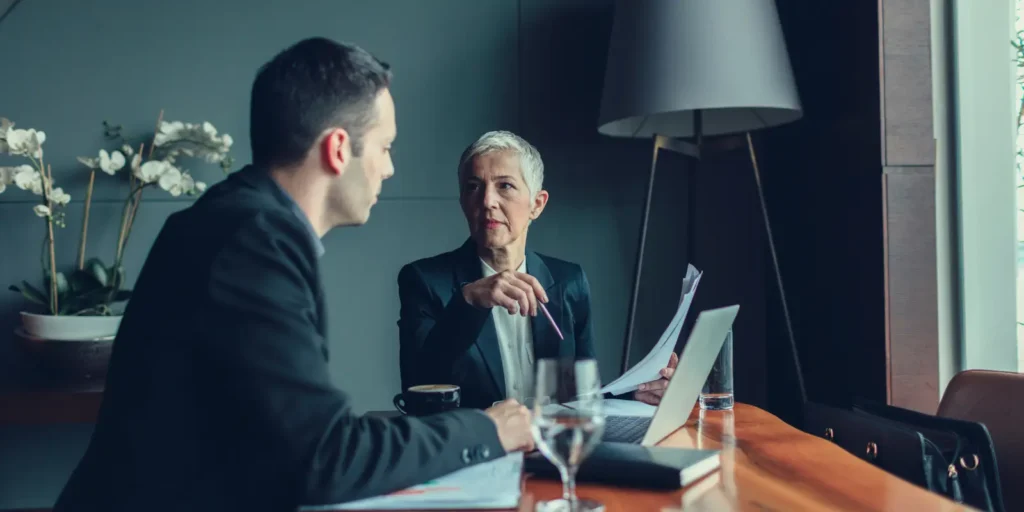 Hospital executives discussing data strategy in a boardroom, representing building a comprehensive Hospital CEO email database.