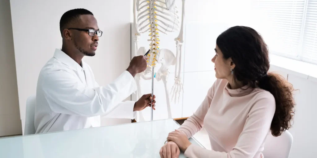 Chiropractor consulting with a patient - Verified Chiropractors Email List by ResearchCaptive