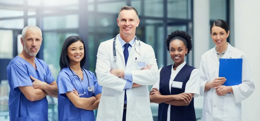 Group of diverse healthcare professionals standing together in clinical setting