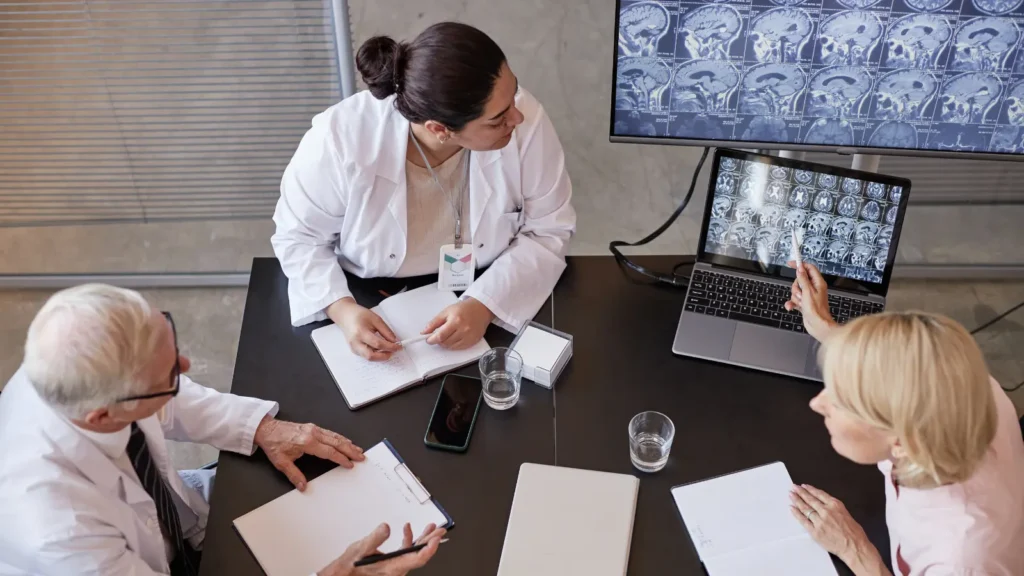 Healthcare team discussing data accuracy and verifying mailing lists for outreach campaigns