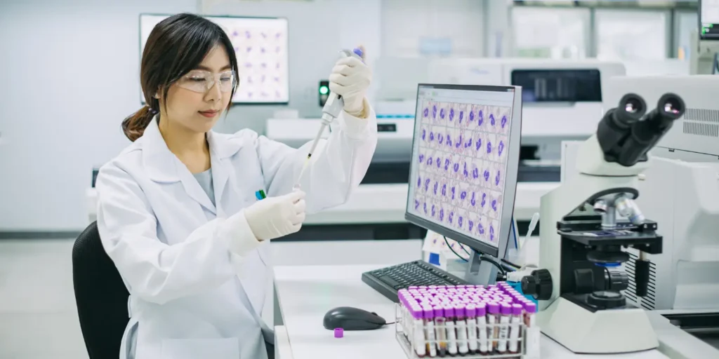 Healthcare professional reviewing patient data – illustrating opt-in strategies for a successful hematology email list.