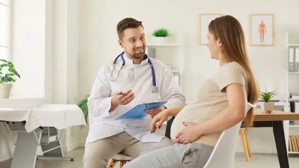 Obstetrician and gynecologist consulting with a female patient in a clinic - understanding OB-GYN healthcare services