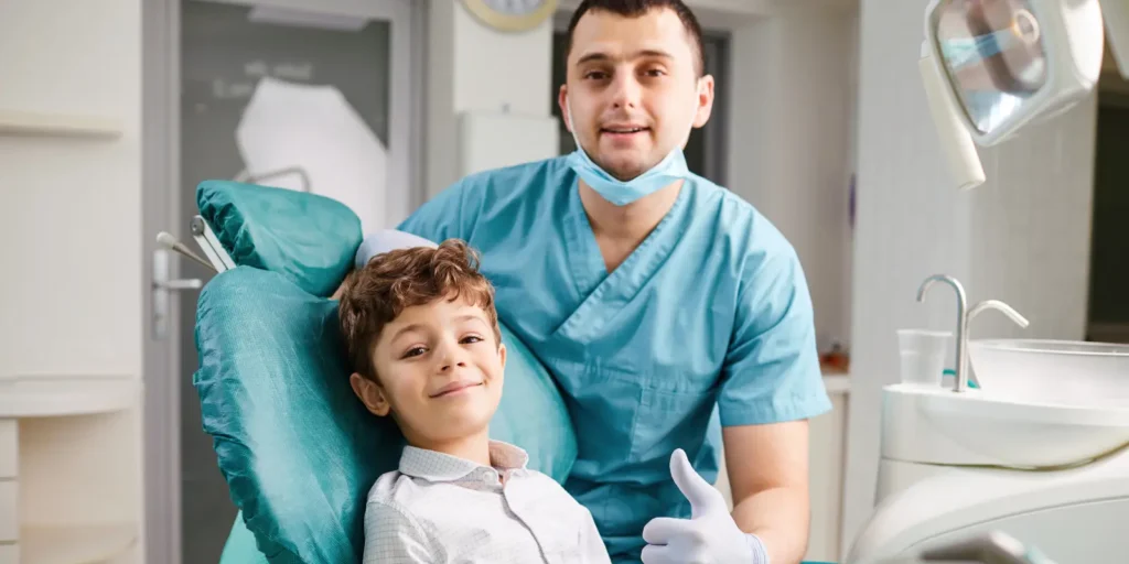 Pediatric dentist providing specialized dental treatment to child patient in modern dental clinic