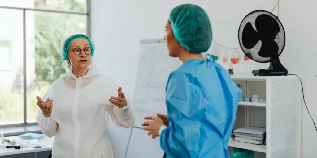 Chief Medical Officer discussing healthcare strategies with medical staff in a hospital setting.