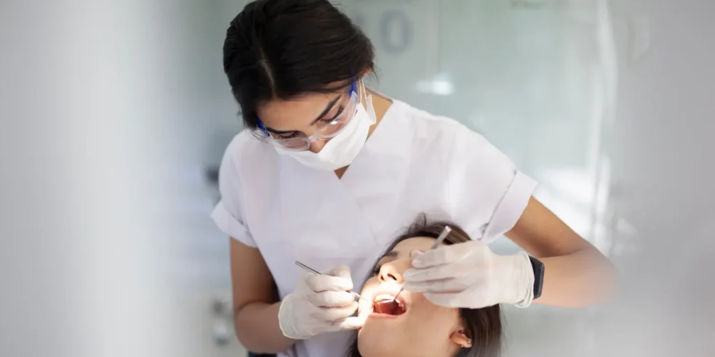 Dental hygienist reviewing educational materials and understanding email list database resources for B2B healthcare marketing and professional lead generation campaigns