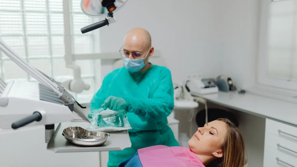 Endodontist performing root canal treatment on patient in modern dental clinic