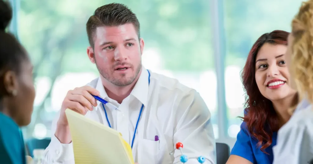 Business professionals discussing geneticist email list strategies during a meeting.