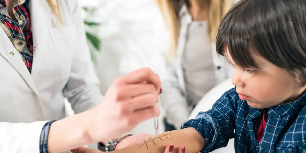 Healthcare professional explaining immunology concepts to a young patient.
