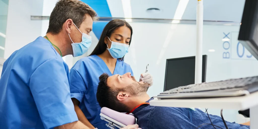 Dental professionals reviewing patient information at the clinic, illustrating insights from the Orthodontist Email List in the USA