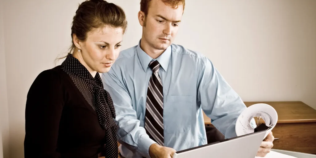 Two professionals reviewing a document for email verification — Verifying Hepatologist Email Addresses