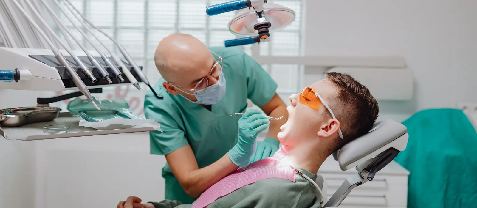 Dental pathologist examines patient in modern clinic, representing New York Oral Pathologists Email List.