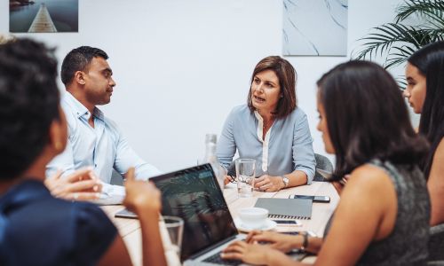 Business professionals in a meeting discussing strategies for reaching decision makers in the healthcare industry using hospital email lists