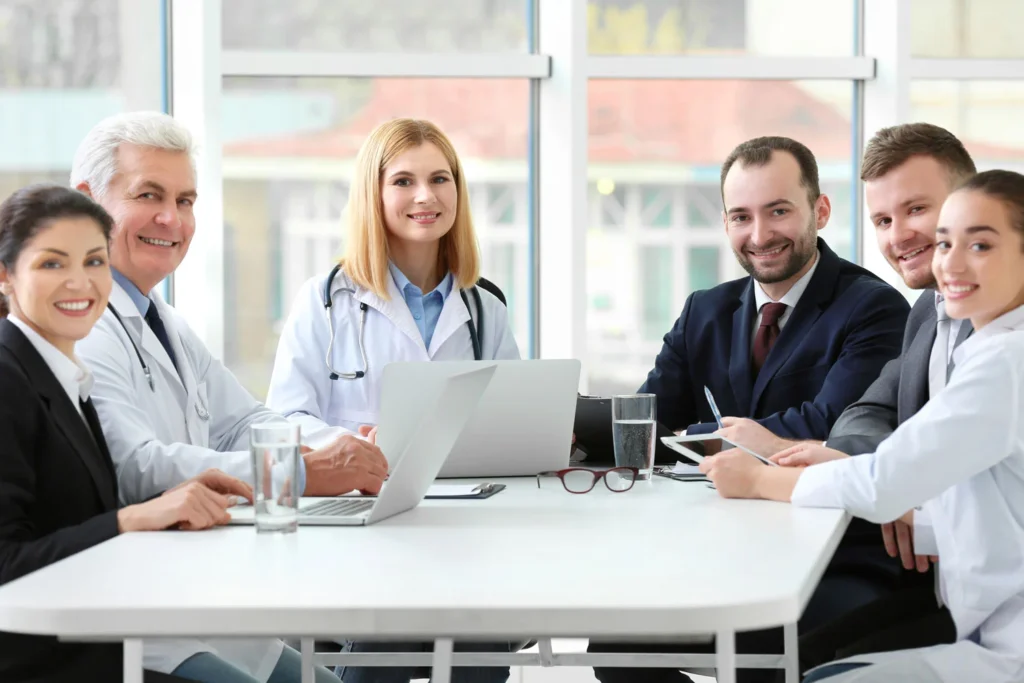 Verified healthcare executives team discussing strategy in a hospital management meeting